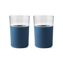 Two Rabbit freezable glasses with blue silicone sleeves, empty and standing side by side.
