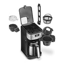 Cuisinart coffee maker shown with lid open, displaying removable grinder, filter basket, water filter, and included components.