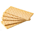 A stack of rectangular, light brown graham crackers with perforated lines and a sprinkling of brown specks on a white background.