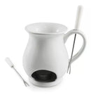 A Swissmar White Ceramic Chocolate Fondue Mug Set, featuring a white fondue mug with a built-in tealight holder and an ergonomic handle, along with two stainless steel fondue forks, perfect for dipping fruits and treats into melted chocolate.