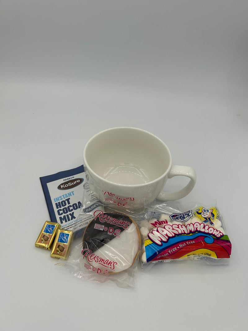 A white Norpro My Favorite Jumbo Mug, Ko-Sure Instant Hot Cocoa Mix packet, a bag of fluffy mini marshmallows, and two Alprose Chocolate Napolitains displayed neatly on a white background.