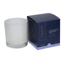 Trapp No. 25 Lavender de Provence 7 oz signature candle in a frosted white glass container, placed next to its elegant navy and lavender packaging.