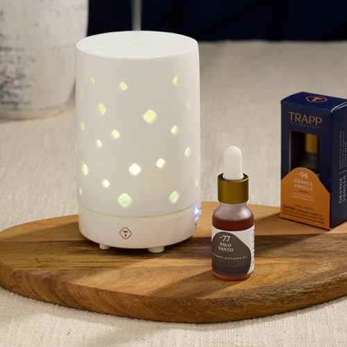 Trapp No. 77 Palo Santo Diffuser Oil displayed alongside a ceramic ultrasonic diffuser with cut-out lighting, creating a cozy ambiance.
