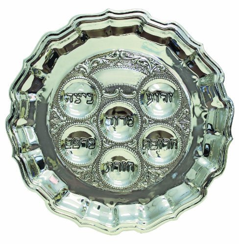 A silver-plated Passover Seder plate featuring a scalloped border, intricate detailing, and six engraved sections with Hebrew labels for the symbolic Seder items.