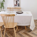A fully set dining table with the white tablecloth (60" x 90"), arranged for a formal meal or Shabbat gathering.