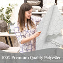 A woman holding and inspecting the tablecloth, emphasizing its high-quality polyester material.