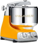 Premium Ankarsrum Original kitchen machine with a vibrant orange base and large, polished stainless steel mixing bowl, ideal for baking and food preparation. This durable stand mixer features chrome accents and a front control panel with two dials for easy operation.
