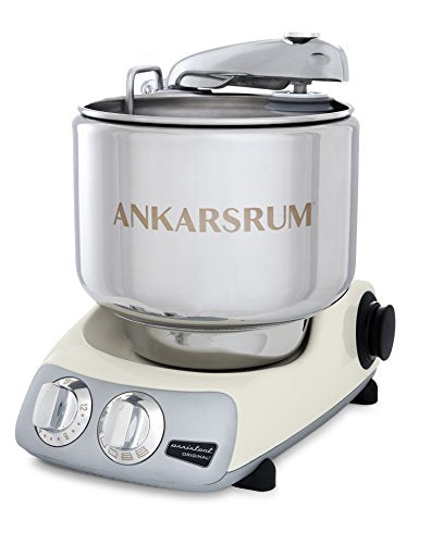 Stainless steel Ankarsrum mixer with a white base, featuring dials for speed control and a large mixing bowl.