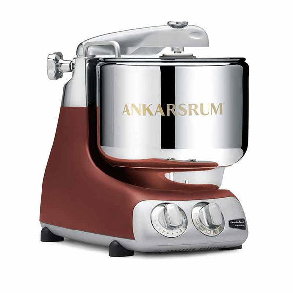 A sleek, modern Ankarsrum mixer in silver and brown, featuring a large bowl and control knobs for easy use in baking and mixing.