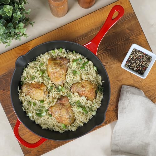 Cooked chicken and rice dish served in red Crock Pot skillet on cutting board
