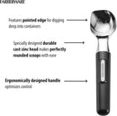 A shiny silver cast-zinc ice cream scoop with a black ergonomic handle.