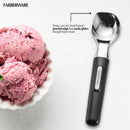A shiny silver cast-zinc ice cream scoop with a black ergonomic handle.
