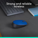 Wireless mouse placed on a desk near a keyboard and notebook