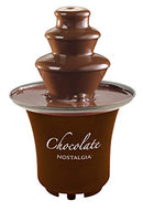 A compact, brown, 3-tier electric fondue fountain flowing with melted chocolate, designed for parties and desserts.