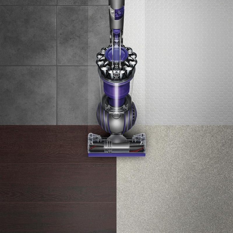 Top-down view of Dyson vacuum on four types of flooring.