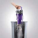 Dust bin being emptied into a trash can.