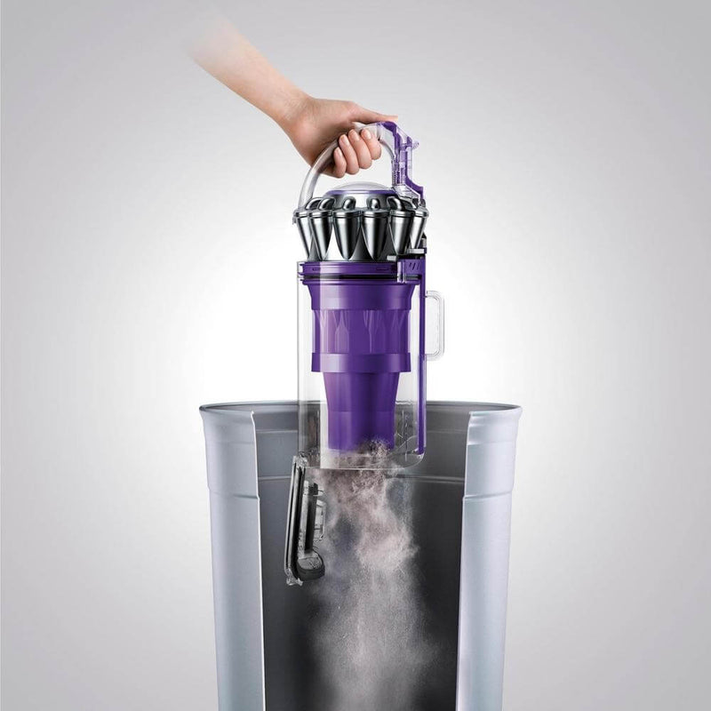 Dust bin being emptied into a trash can.