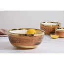 Angled side view of large wood-look porcelain bowl with a lemon inside and more bowls in background