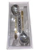Two-piece gold and silver salad serving set with elegant handles in a clear-lid gift box labeled “Metropolitan”