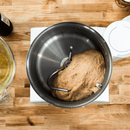 Top-down view of dough being mixed in the stainless steel bowl