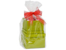 Stacked green gift boxes wrapped in clear cellophane with a red mesh bow on top