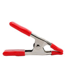 Steel spring clamp with red rubber-coated handles and jaw tips, designed for light-duty clamping and holding.
