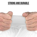 Close-up of hands pulling and stretching a plastic mattress bag under the caption "Strong and Durable," demonstrating its tear-resistant material.