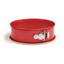 A round, 9-inch springform pan with a red exterior, a nonstick interior, and a shiny silver metal side clasp.
