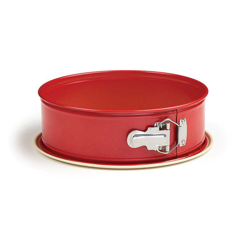 Side view of a 9-inch red springform pan with a metal latch and beige nonstick base.