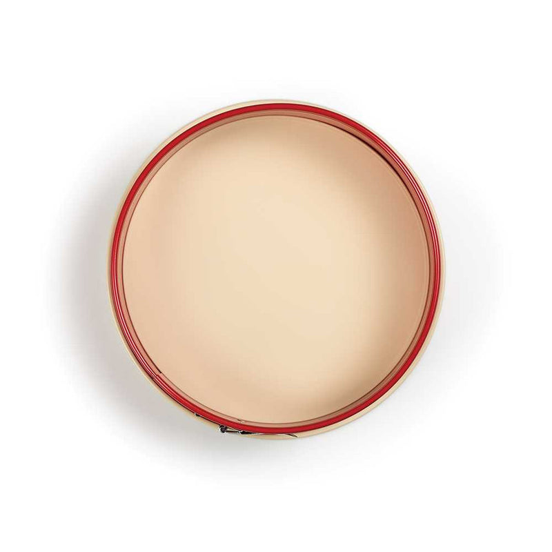 Top view of a 9-inch red springform pan showing the circular beige nonstick baking surface.