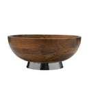 Round wooden serving bowl resting on a contrasting silver hammered base