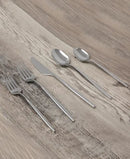 Flatware set neatly displayed on a wooden table surface