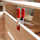 Clamp gripping wooden panel during assembly