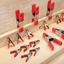 Multiple clamps displayed on wood surface in various sizes