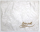 White challah cover with elegant wavy line pattern and gold embroidered Hebrew text in the lower right corner