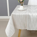 Elegant ivory and metallic-striped rectangular tablecloth on a modern dining table, sized 60x90 inches.