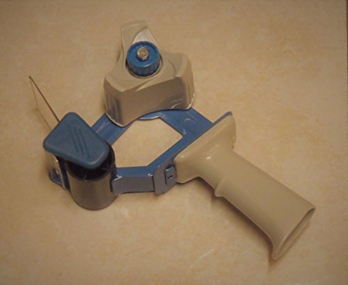 Beige and blue heavy-duty packing tape dispenser with ergonomic handle and adjustable tension knob on a flat surface