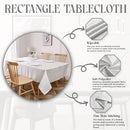 Silver jacquard-patterned polyester tablecloth spread over a long dining table with elegant décor