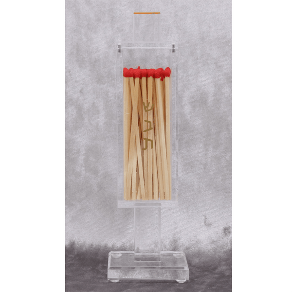 Clear acrylic matchbox holder with red-tipped wooden matches displayed vertically