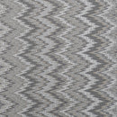 A textured fabric pattern featuring alternating gray chevron zigzags in various shades, creating a dynamic, modern visual effect.