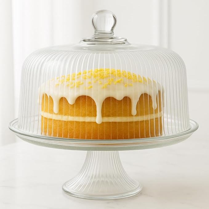Close-up of iced cake under glass dome on Anchor Hocking crystal cake stand