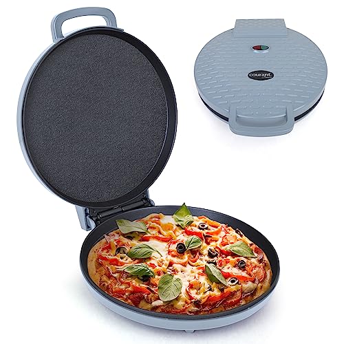 Open electric pizza maker with a fresh pizza inside and closed lid in the background