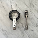 Stacked measuring cups and spoons on marble surface