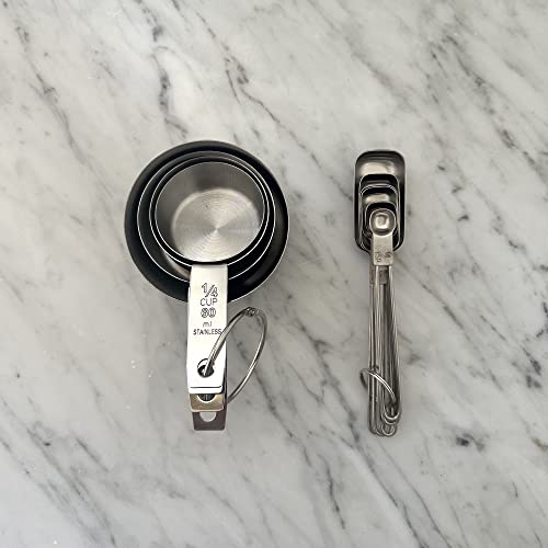 Stacked measuring cups and spoons on marble surface