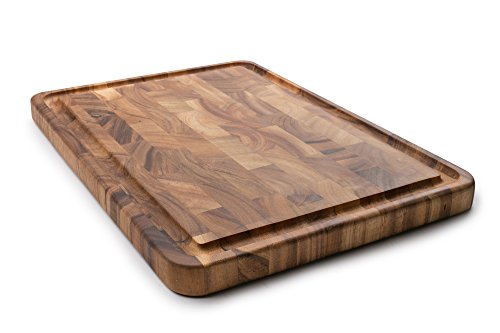 Angled view of acacia end grain cutting board showing thickness and juice channel