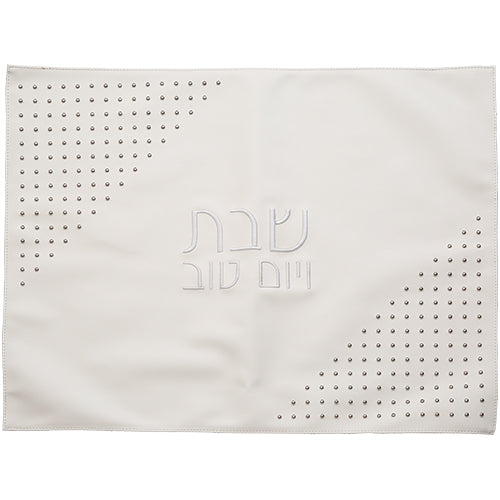 White challah cover with embossed Hebrew text "Shabbat VeYom Tov" and decorative perforated corner design