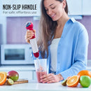 Woman using red OVENTE cordless hand blender to blend ingredients in a cup