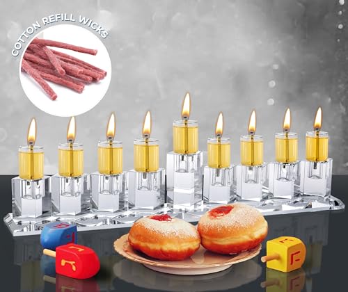 Lit menorah with Ner Mitzvah oil wicks burning evenly beside sufganiyot.