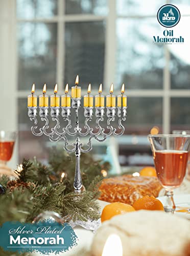 Menorah centerpiece on a holiday table surrounded by food and candles.