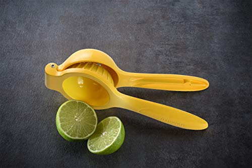 Yellow lemon squeezer with halved lime on dark countertop